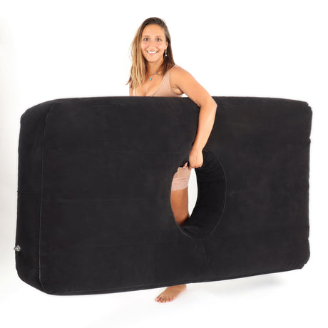 Yesindeed black inflatable mattress held upright to show its overall shape and central opening