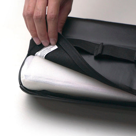 Close view of the Yesindeed cushion cover opened to show its zipper, label and inner cushioning